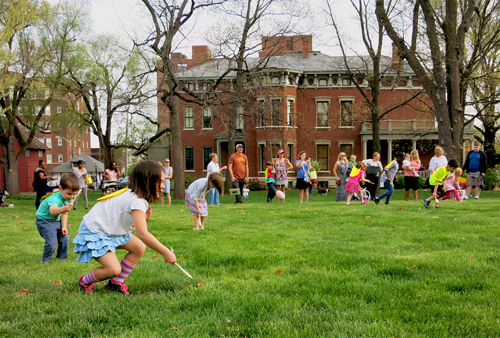 Photographic image of lots of kids on the lawn of the presidential site.