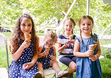 photograph of a group of young girls photographed at a benjamin harrison presidential site event, each eating an ice cream cone on a warm summer's day.