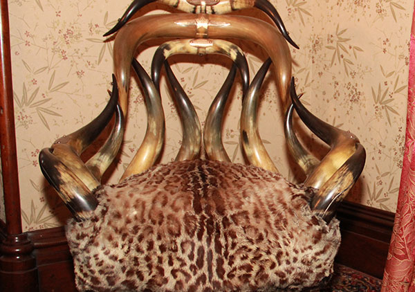 Several plaque on the back and arms of the chair convey the following: Top plaque: 