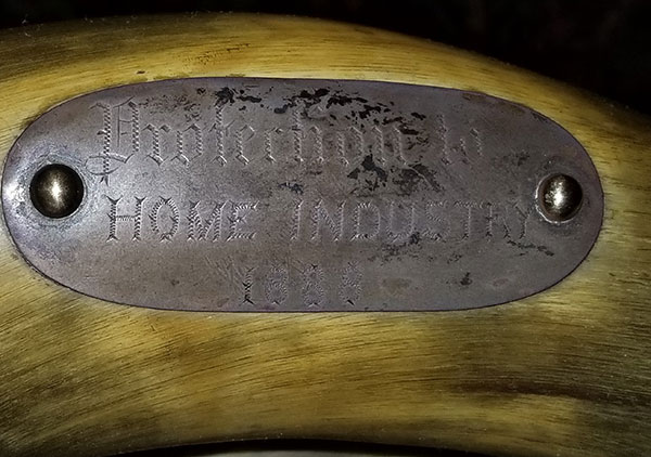 Several plaque on the back and arms of the chair convey the following: Top plaque: 