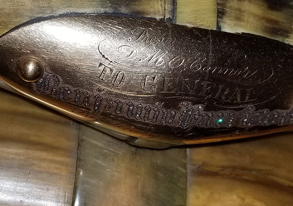 Several plaque on the back and arms of the chair convey the following: Top plaque: 