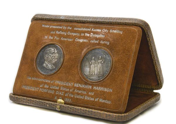 A brown box that has the appearance of being made from snakeskin; box opens up and medals swing out to prop the top up as a display case; two medals inside-one is intended for the President of the United States of America and the other is intended for the President of the United States of Mexico. Marked: 
