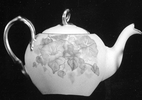 Tea pot hand-painted with morning glories by Mrs. Caroline Scott Harrison in pastel tones, green leaves and gold trim. Tea pot has a lid and gold twig like handles.