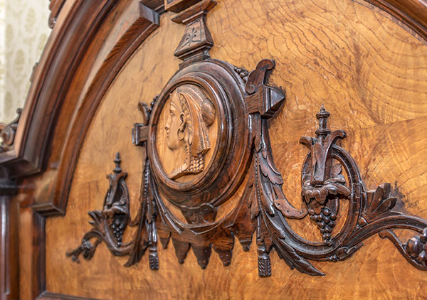 Original Harrison large rosewood and satinwood Renaissance Revival bed. Satinwood panel in tall head board. Large Egyptian medallion in center of head board that matches smaller medallions in chairs. The head board is 8 feet tall with squared feet. Squared urn design on foot board. Foot board has round massive legs. Ornamental pieces in medallions, scrolls, etched designs, etc.